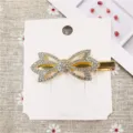 Close-up detail shot of a sparkling rhinestone bow hair clip displayed on white card. - 9# Hair Clip (Hollow Bowknot)