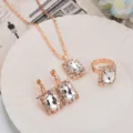 Rose gold tone rectangular crystal necklace earrings and ring jewelry set variant display photo. - Square / White