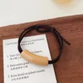 Minimalist milk tea color hair tie with curved tube decor for sweet daily hairstyles. - Cylinder / Khaki