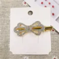 Rhinestone bow hair clip detail shot, showing sparkling crystals and gold metal duckbill. - 16# Hair Clip (Streamline Bowknot)