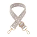 Close-up of the jacquard embroidered strap details, featuring adjustable gold hardware and clasp. - Beige Light Purple