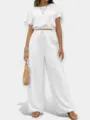 Conjunto de dos piezas con top corto cuello redondo liso y pantalón ancho tiro alto. - Blanco