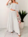Detailed view of white off-shoulder crop top and wide-leg pants two-piece set in a modern room. - S / Top And Bottom / White