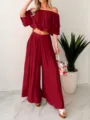 Chic burgundy off-shoulder ruffle crop top and wide-leg pants two-piece outfit detail. - Red