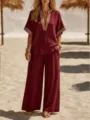 Wine red casual two-piece set with V-neck top and wide-leg trousers detail shot. - Burgundy