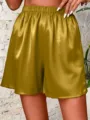 Vista detallada de pantalones cortos casuales de mujer de satén con cintura elástica. - Dorado