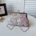 Exquisite embroidered kiss-lock crossbody bag featuring detailed floral patterns and gold chain. - Pink