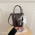 Dark brown bucket bag fine product detail, featuring cute white lace bow and star charm. - With Pendant / Brown