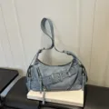Vintage distressed light blue motorcycle shoulder bag with multiple zippers and buckle. - Blue