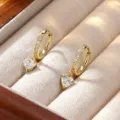 Elegant gold hoop earrings with heart-shaped moissanite dangle in jewelry box - Heart Shape Moissanite Drop Style / Gold