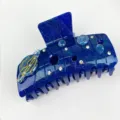 Detailed close-up view of dark blue galaxy hair claw clip with rhinestones and planet charm - 10.2cm / Dark Blue