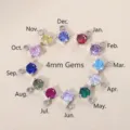 Set of 12 birthstone pendants with 4mm round zircons and stainless steel settings. - March Aquamarine Zirconia / Steel