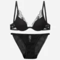 Front view of a delicate black lace bra and mesh panty lingerie set on a white background. - S / Black