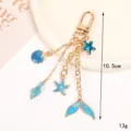 Elegant blue enamel ocean theme keychain with mermaid tail and starfish charms for bags - Shell Conch Style