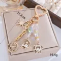 Elegant gold beaded keychain featuring moon cat and star charms for bag accessories - Rhinestone Cat Hexagram Style (K1769)