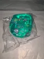 Nahaufnahme eines grünen, durchsichtigen Quetschspielzeugs mit Muscheln und Sternen innen - OPP-Beutel / 1 Stück (5x5cm) / Grün