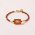 Elegante Evil Eye kralenarmband met amberkleurige steen en fonkelende zirkoon inleg - Armband / Amber