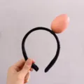 Funny headband for girls featuring a realistic plush egg design on a soft black band - Egg