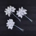 Close-up of white 12-head artificial rosebud clusters perfect for DIY wedding crafts. - White