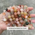 Handcrafted natural multi-color rabbit hair crystal beaded bracelet shown in hand. - 3A Natural Red Rabbit Hair Crystal Bracelet