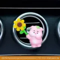 Creative pink cartoon pig car air vent aromatherapy clip holding a yellow sunflower - Pink Pig Air Vent Decor (Standing Style)