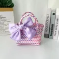 Close-up of hand-woven colorful gift bag featuring a large satin purple bow decoration - Small (With Pink Bow) / Pink Purple