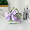 Handmade colorful woven handbag featuring a large purple satin bow in lifestyle decor. - Small (With Purple Bow) / Green Purple