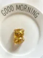 A golden glitter transparent bear squishy toy presented on a minimalist white plate - Gold
