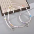 Elegante pastellrosa Perlen-Umhängekette mit Stern- und Blumenanhängern für Taschen und Handys - Lotus & Anhänger Crossbody Kette / Hellrosa