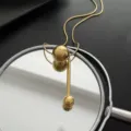 Minimalist gold titanium steel necklace with geometric sphere and bar pendant design - Small Ball Style / Gold