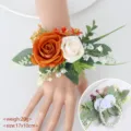 Elegant wedding wrist corsage featuring orange and cream roses with a pearl bracelet - Wrist Corsage / Champagne Orange