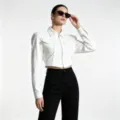 Detailed shot of white slim fit cropped denim jacket with front zipper and collar - S / White