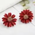 Close-up detail of elegant matte red chrysanthemum flower earrings with gold wire center - Red