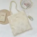 French vintage off-white tote bag featuring delicate floral embroidery and hollow design - Hollow Rose Shoulder Bag / Off White