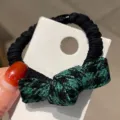 Chouchou elastique noir avec noeud papillon pied-de-poule vert, accessoire de coiffure chic. - Nœud Vert