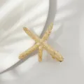 Gouden zeester haarspeld detailopname, elegante metalen haarclip voor dames dagelijks. - Gouden Zeester