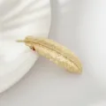Gold feather hair clip detail view, elegant metal hairpin close-up for women daily styling. - Gold Leaves