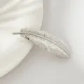 Close-up detail shot of a silver feather hair clip, showing exquisite leaf texture and shiny metal. - Silver Leaf Bracelet