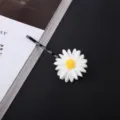 Detailed shot of a sweet daisy hair clip with a black bobby pin for cute everyday hairstyles. - Single Flower Bobby Pin