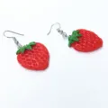 Detailed view of cute red strawberry resin dangle earrings featuring silver hooks for sweet style. - Half Strawberry Ear Hook