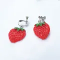 Close-up detail of cute red strawberry clip-on earrings with green leaves and metal screw backs. - Half Strawberry Ear Clip