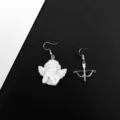Primer plano detallado del diseño de pendientes asimétricos de ángel y arco flecha. - Ángel y Arco Asimétricos / Estilo A Gancho de Oreja