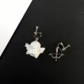 Primer plano de los detalles de los pendientes de clip asimétricos de ángel y arco. - Ángel y Arco Asimétricos / Pendientes de clip modelo D