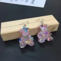 Detailed shot of cute translucent pink glitter bear earrings with colorful foil accents. - Earring Hooks / Pink
