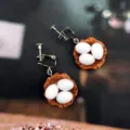 Closeup of handmade funny fried egg nest resin ear clips, quirky food play jewelry detail view. - Brown Egg Clip Earrings