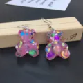 Detailed view of cute pink glitter resin bear dangle earrings, charming sweet style jewelry. - Earring Hooks / Hot Pink