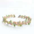 Close-up of colorful floral lace choker necklace, delicate embroidered flower collar accessory. - Pink Green