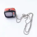 Detailed close-up shot of the vintage miniature retro television pendant on silver ball chain. - Red and Black TV