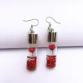 Chic dried flower glass bottle dangle earrings featuring vibrant red floral design and glitter. - Red