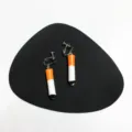 Detail view of creative handmade cigarette clip earrings with unique punk style design. - Clip-On Earrings